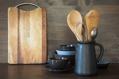 Çanak çömlek, clayware, karanlık kaplar ve ahşap masa üstü diğer farklı şeyler. Mutfak tasarımı için arka plan olarak natürmort. Kopya alanı.