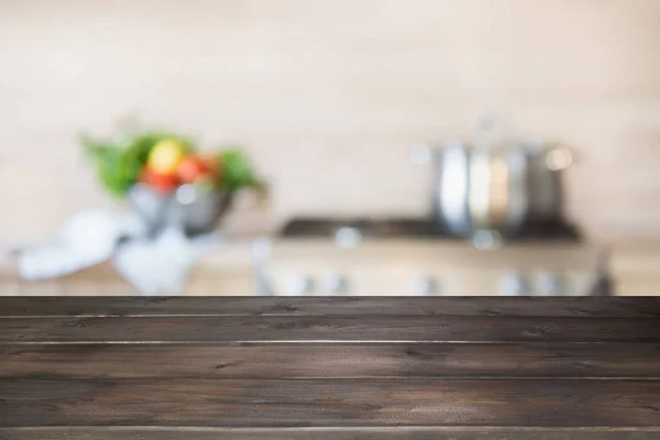 Elmosódott háttér. Modern konyha üres fa asztali és a hely az Ön számára. — Stock Fotó