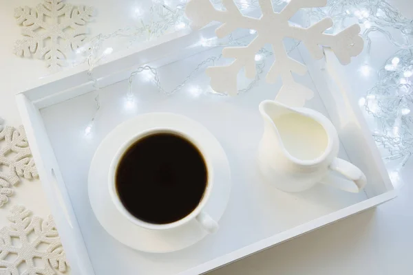 Cup of black coffee on winter white table. Xmas holiday time. Top view. — Stock Photo, Image