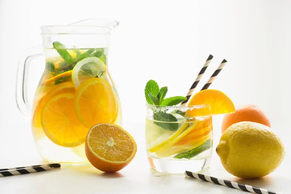 夏のデトックスのレモネード レモン オレンジ 氷コップ白地にミントと水 クローズ アップ — ストック写真