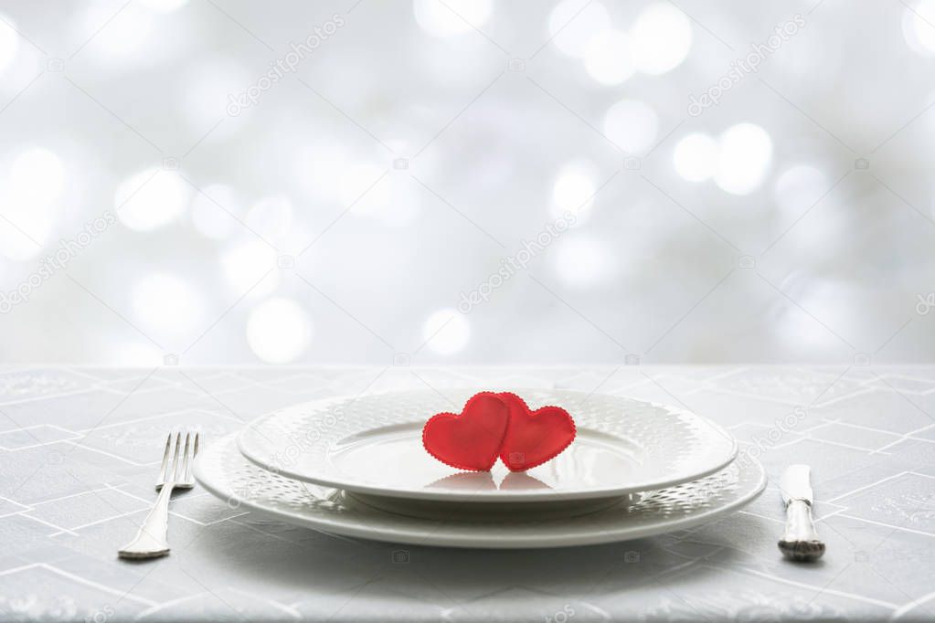 Valentines day table place setting with two hearts in cafe. Space for text. Invitation for a date.