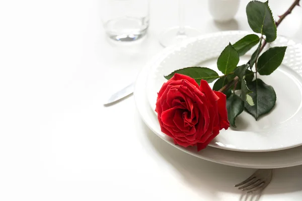 Valentine\'s day or birthday romantic dinner. Elegance table setting with red rose.