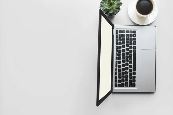 Workspace with open laptop, documentation, and cup of black coffee. Top view with copy space. Office business concept. Working process. Flat lay slyle.