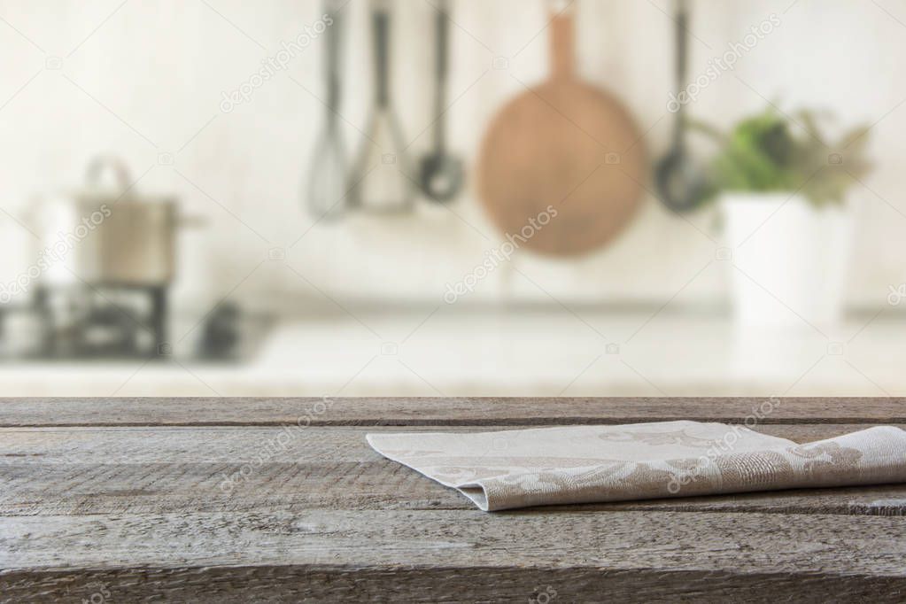 Blurred abstract background. Modern kitchen with wooden tabletop, space for you and display products.