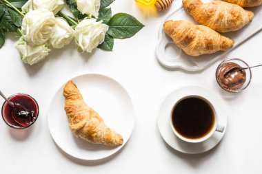 Bir fincan kahve ve taze pişmiş kruvasan. Üst te. Kadın kahvaltısı.