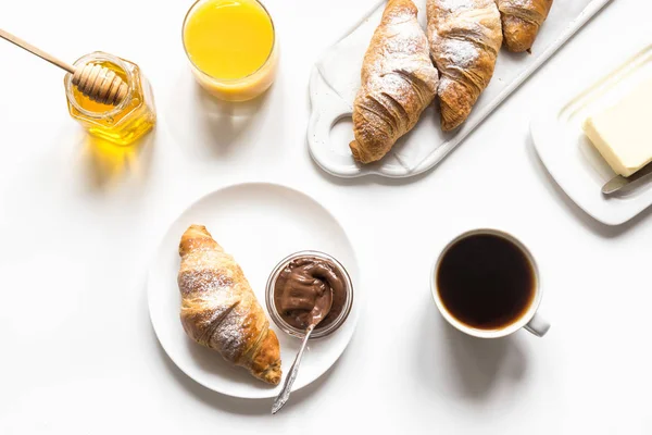 Freshly baked croissants and cup of coffee on white. Space for text. French breakfast. — Stock Photo, Image