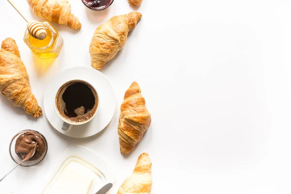 Cup of coffee and freshly baked croissants. Top view. Copy space — Stock Photo, Image