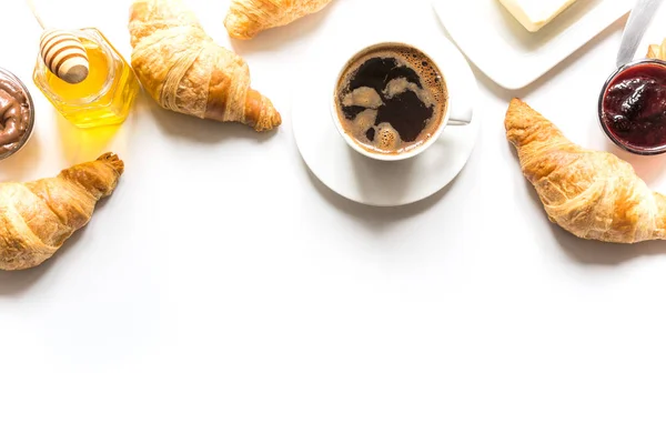 Cup of coffee and freshly baked croissants. Top view. Copy space — Stock Photo, Image