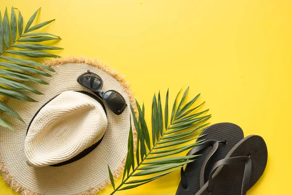 Női strand szalma kalap, napszemüveg, flip papucs és Tenyér sárga. Felülnézet. Nyári utazási koncepció. — Stock Fotó