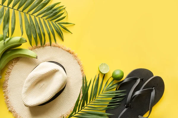 Female beach straw hat, sunglasses, flip flops and palm on yellow. Top view. Summer travel concept. — Stock Photo, Image