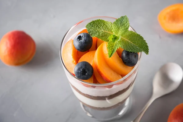 Apricot trifle, chocolate biscuit, layered dessert with fresh berry and gentle cream cheese.