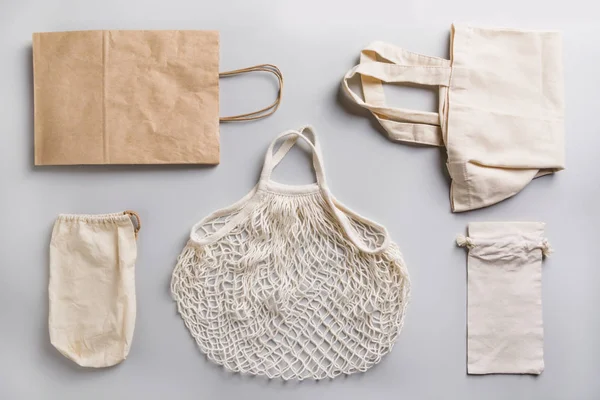 Paper, cotton and mesh bags for zero waste shopping on grey. Zero waste concept.