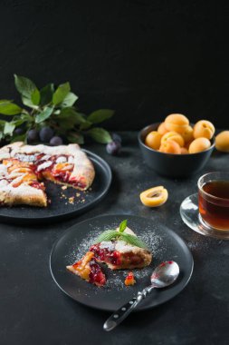 Siyah masada erik ve kayısı ile lezzetli sonbahar pasta galette.