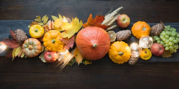 Fall decor for Thanksgiving Day with pumpkins, leaves, apples, lights on wooden table. — Stock Photo, Image