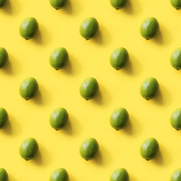 Seamless limes pattern on yellow background. Food concept. Flat lay. Top view.