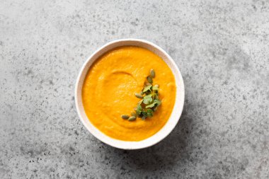 Gri taşın üzerinde balkabağı çorbası garnitür mikro yeşillikleri. Üst görünüm.