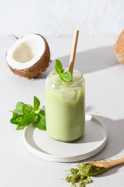 stock image Iced latte green matcha tea with coconut milk garnish mint on white background.