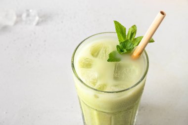 Beyaz masada izole edilmiş buzlu yeşil kibrit çayı. Kapat.