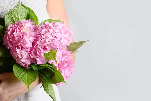 Bouquet of fresh pink hydrangea flower woman hands. Flowers delivery. Floral shop concept. Handsome fresh bouquet. Banner.