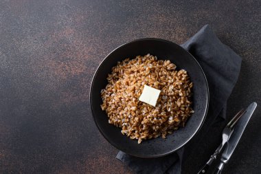 Koyu kahverengi arka planda tereyağlı tam tahıllı mısır gevreği pişirdim. Üst Manzara. Metin için boşluk.