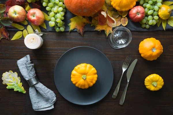 Fall table place setting decorated vegetables, grape, pumpkins, aplles, harvest. Thanksgiving Day