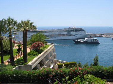   Monte Carlo, Monako -17 Temmuz, 2007: Görünümü büyük yolcu gemisi Msc Sinfonia için Monte Carlo Kumarhanesi ve küçük gemilerle bağlantı noktası Herkül Monako yakınlarında deniz bahçesinden. 