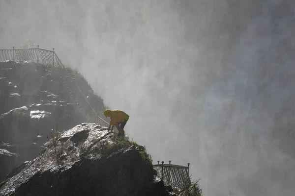 Man walking against the big waterfall in Tortum. Explore the world\'s beauty and wildlife. Man on a Great waterfall