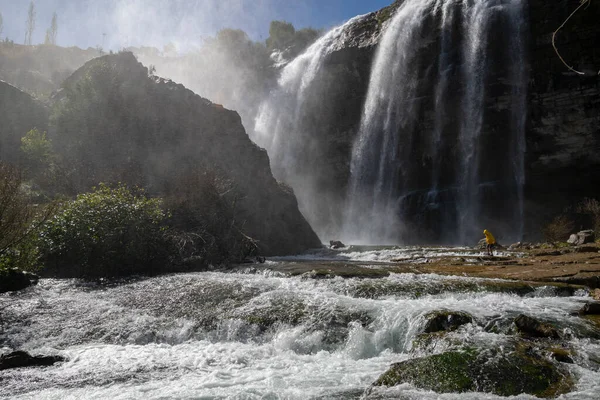 Man walking against the big waterfall in Tortum. Explore the world's beauty and wildlife. Man on a Great waterfall