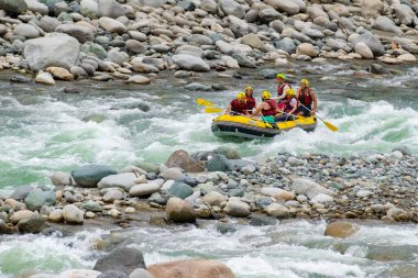 Kaba bir akıntıda rafting yaparken kayıktaki insan grupları, Türkiye 'nin Rize kentinde bir dağ nehrinde akın ediyor.