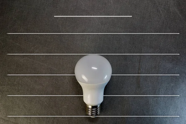 Top view of LED light bulb on gray background with copy space, flat lay — Stock Photo, Image