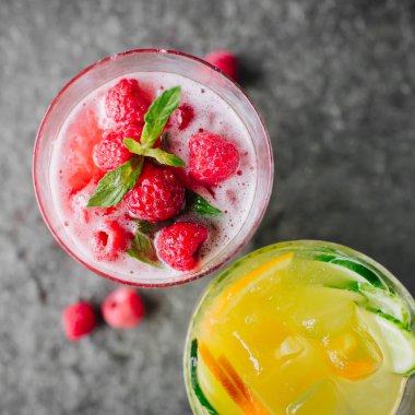 Salatalık ve taş masanın üstüne çilek limonata ile turuncu limonata