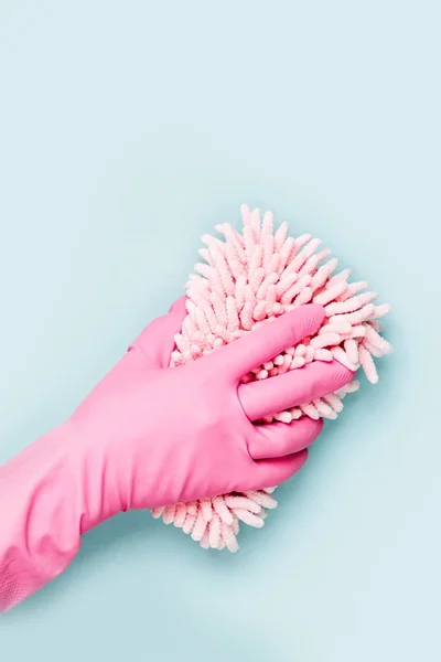 Female hands cleaning on blue background. Cleaning or housekeeping concept background. Copy space.  Flat lay, Top view.