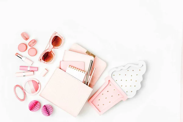 Cosmetic products, sunglass, handbag on white background. Flat lay, top view. Fashion concept