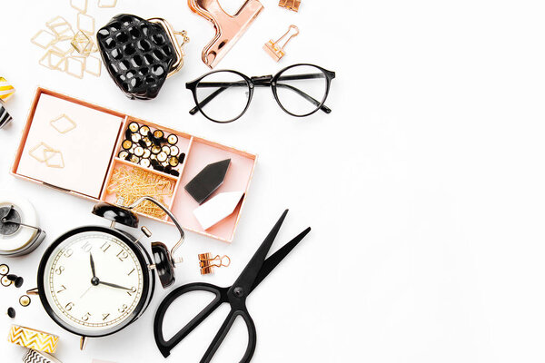 Flat lay stylish set: alarm clock, washi tape,  paper clips, note on white background. Flat lay, top view. Business Stationery concept.