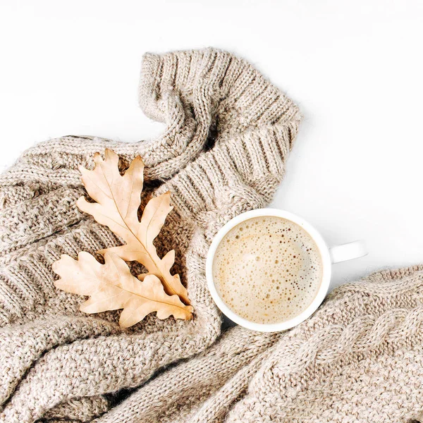 Cup of coffee  with warm plaid and dry leaves