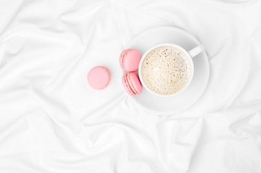 yatakta Kupası Kahve ve macaroons ve üstten görünüm 