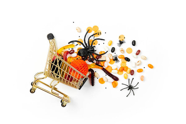 Halloween treats in a shopping cart on white background