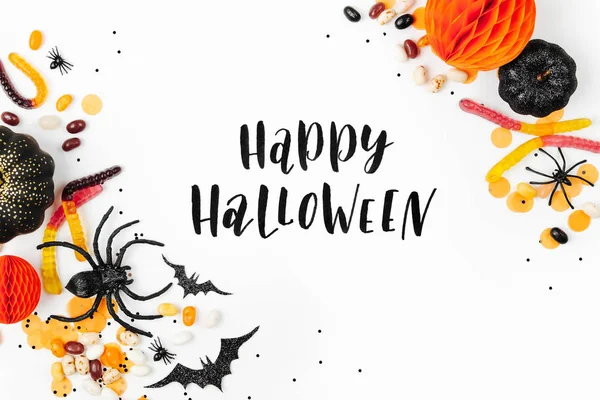 holiday poster with candies, decorations and happy halloween lettering