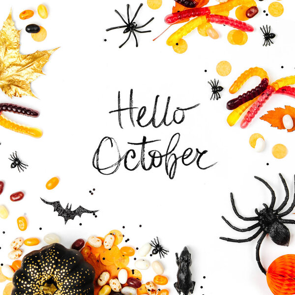 Halloween holiday poster with candies, decorations and hello october lettering 