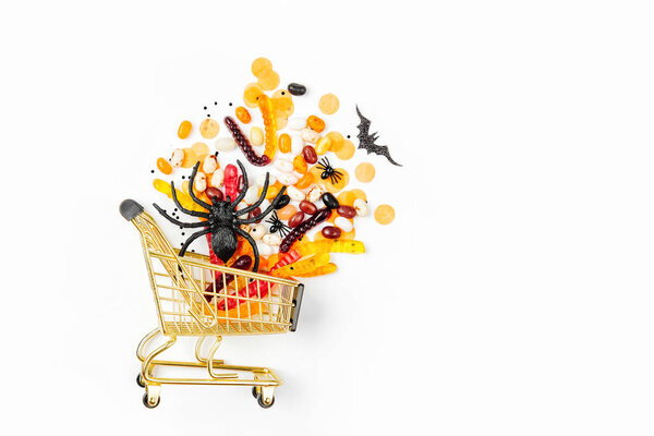 Halloween treats in a shopping cart on white background