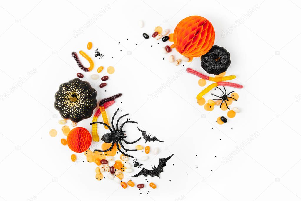 Halloween holiday background with candies, bats, spiders, pumpkins and decorations