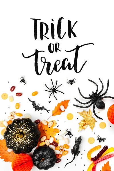 Halloween holiday poster with candies, decorations and trick or treat lettering