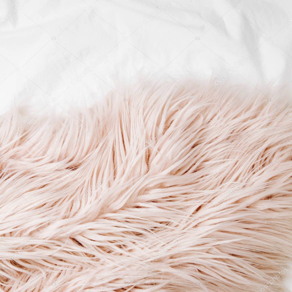 top view of pink fluffy fur plaid on bed