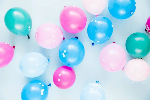 festive background with colorful balloons on pastel blue background