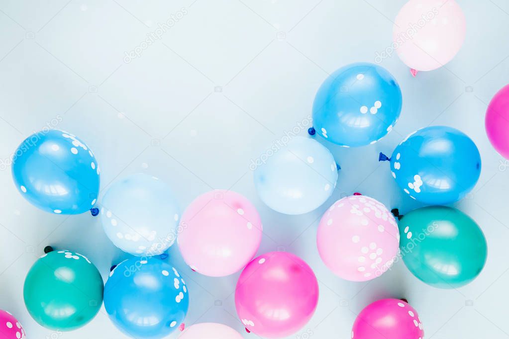 festive background with colorful balloons on pastel blue background