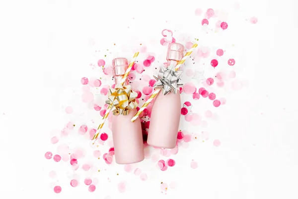 Mini Garrafas Champanhe Rosa Pálido Com Confete Sobre Fundo Branco — Fotografia de Stock