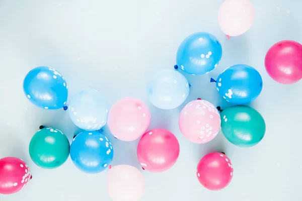 festive background with colorful balloons on pastel blue background