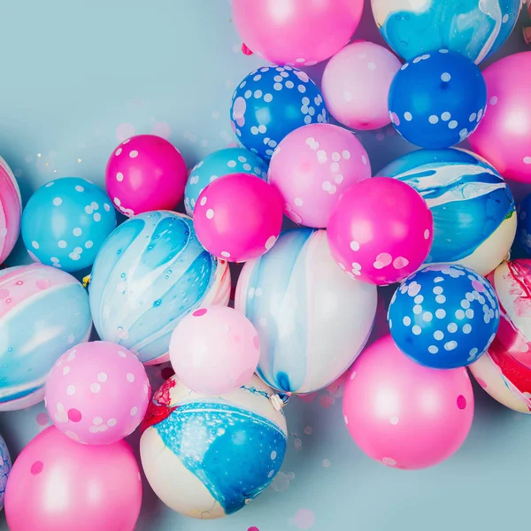 Colorful balloons on pastel colored background