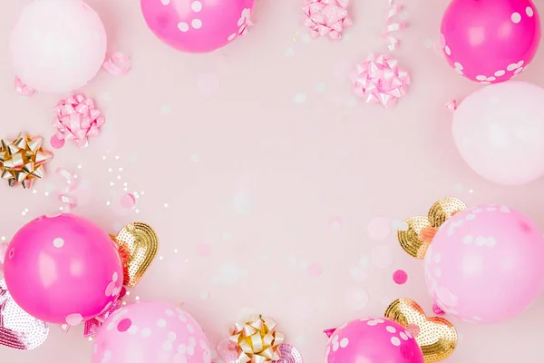 festive frame of pink balloons and decorations