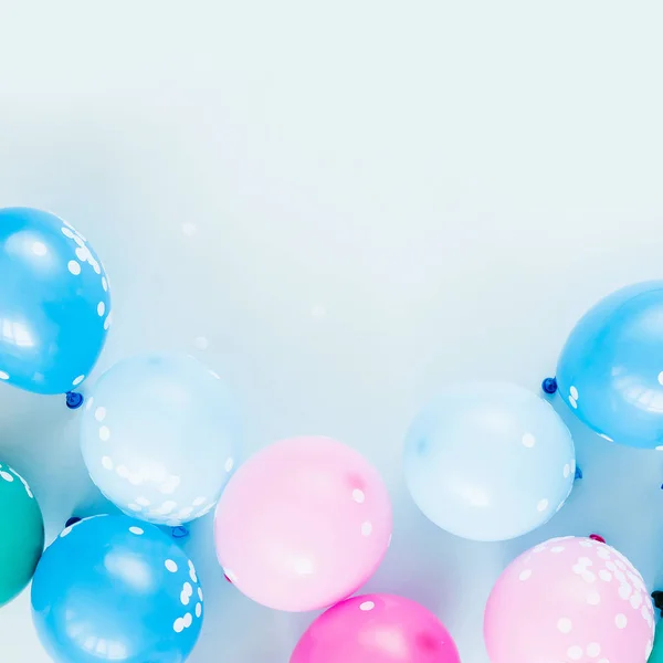 Colorful balloons on pastel colored background